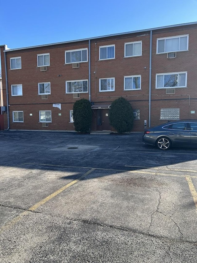 view of building exterior featuring uncovered parking