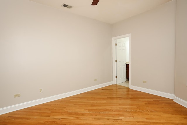 unfurnished room featuring light wood finished floors, visible vents, ceiling fan, and baseboards