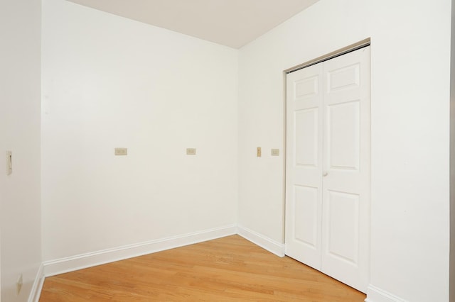 interior space with baseboards and light wood-style floors