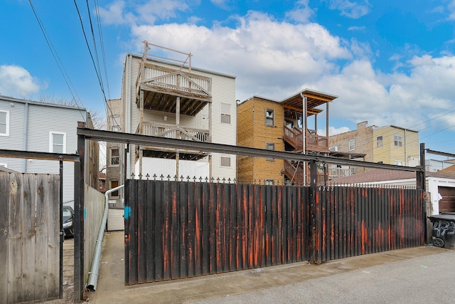 exterior space featuring a balcony and fence