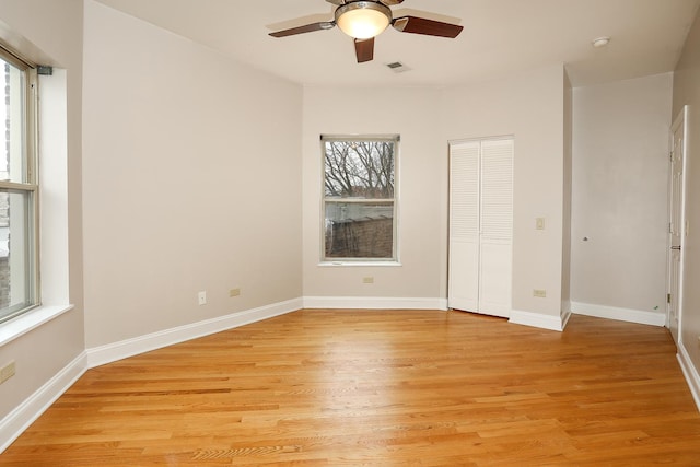 unfurnished bedroom with visible vents, baseboards, a closet, and light wood finished floors