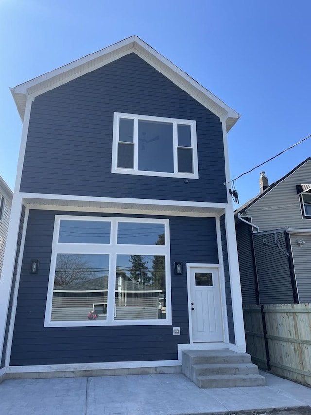 view of front of property featuring fence