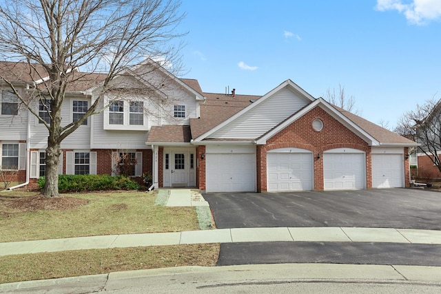 view of front of property with a front yard, a shingled roof, a garage, aphalt driveway, and brick siding