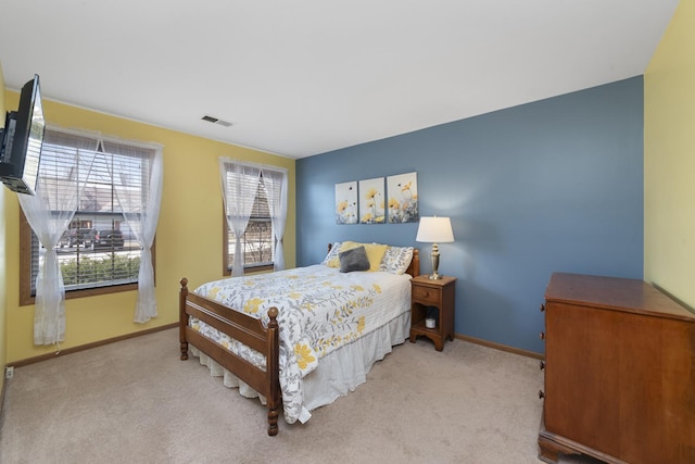 carpeted bedroom featuring visible vents and baseboards