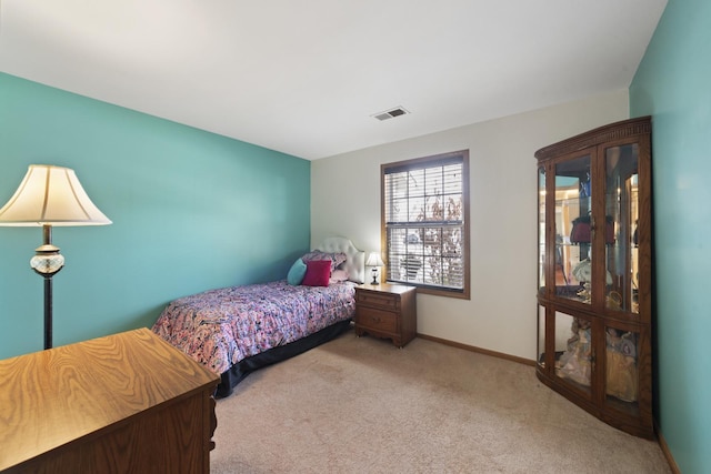 carpeted bedroom with visible vents and baseboards