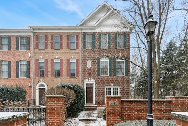 townhome / multi-family property with brick siding