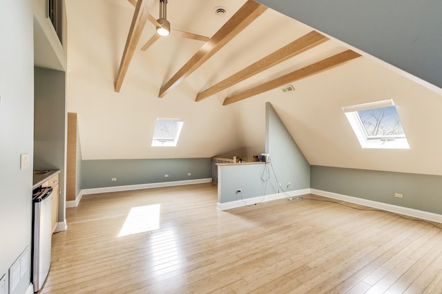 bonus room featuring light wood-style flooring, a ceiling fan, and visible vents