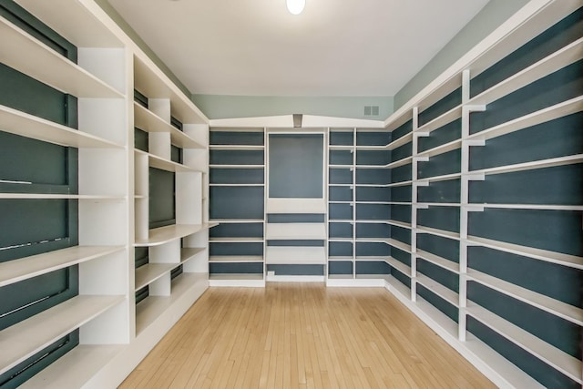 spacious closet with hardwood / wood-style flooring and visible vents