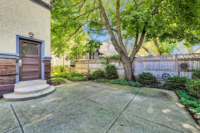 view of patio with entry steps and fence