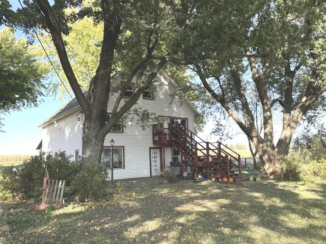 rear view of property featuring stairway