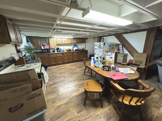 kitchen with dark countertops, light wood-style flooring, and brown cabinets