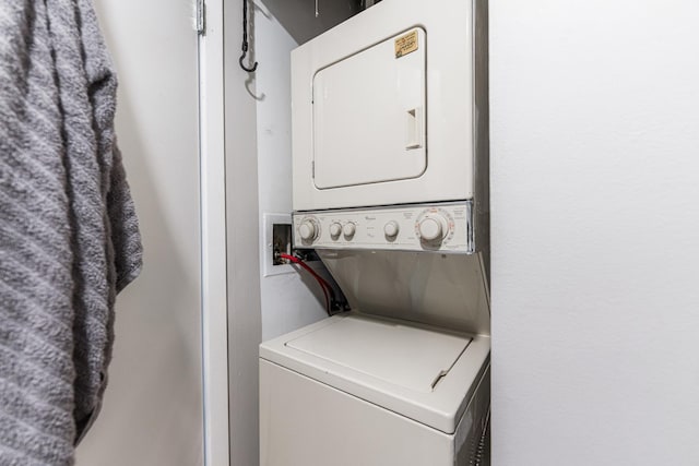 clothes washing area featuring laundry area and stacked washer and dryer