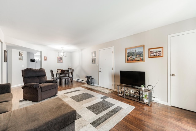 living area with wood finished floors, baseboards, and a baseboard radiator