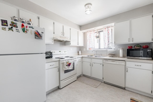 kitchen featuring under cabinet range hood, light countertops, white cabinets, white appliances, and a sink