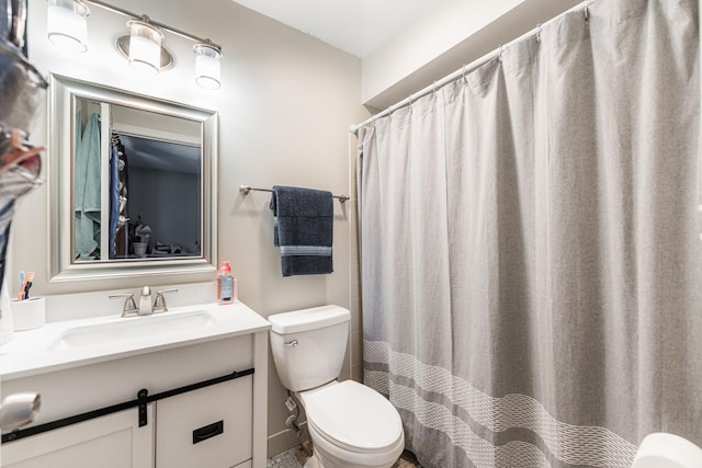 full bathroom with toilet and vanity