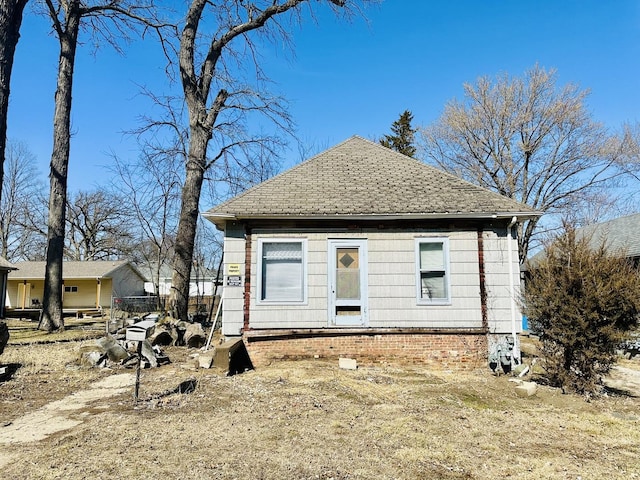 exterior space featuring roof with shingles