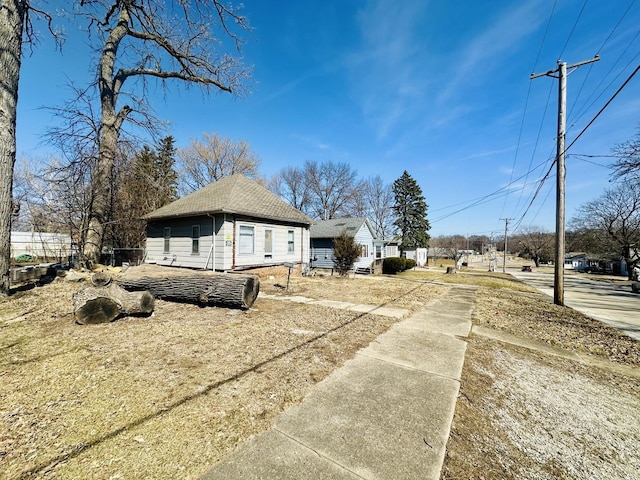 view of home's exterior featuring roof with shingles