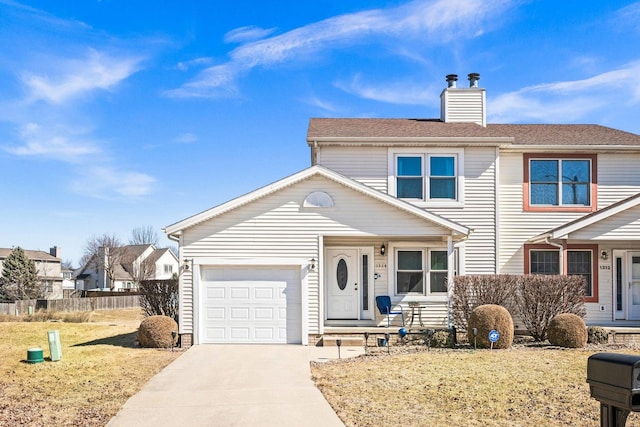 view of front of home featuring driveway, a chimney, a garage, and fence