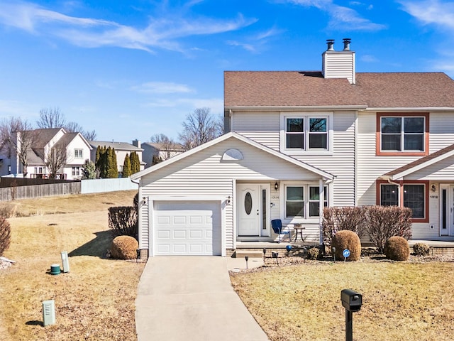 view of front of property with a garage, a chimney, driveway, and fence