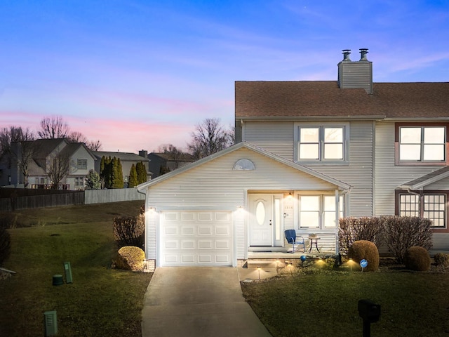 view of front of property featuring a front yard, roof with shingles, a chimney, a garage, and driveway