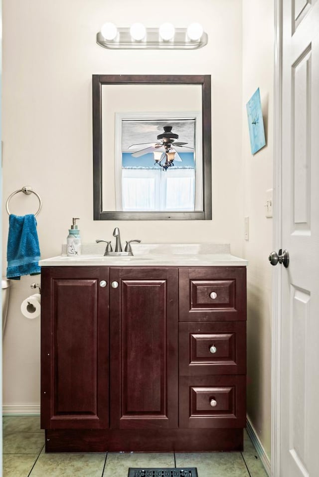 bathroom with tile patterned floors, baseboards, vanity, and a ceiling fan