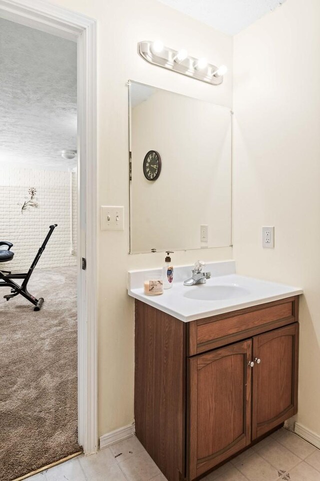 bathroom featuring tile patterned flooring and vanity