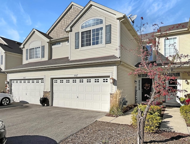 view of front of property featuring driveway and a garage