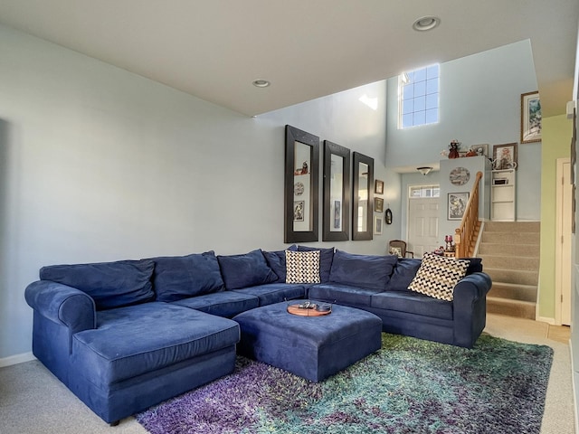 living room with carpet, baseboards, a high ceiling, recessed lighting, and stairs