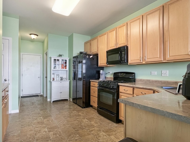 kitchen with baseboards, black appliances, and light brown cabinets