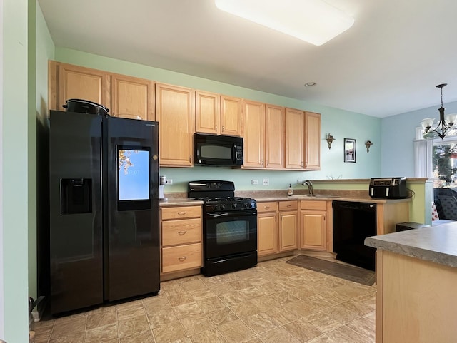 kitchen with black appliances, a notable chandelier, a peninsula, and light brown cabinetry