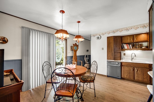 dining area with a wainscoted wall and light wood-type flooring