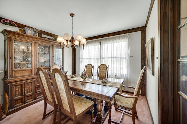 dining room featuring light colored carpet and an inviting chandelier