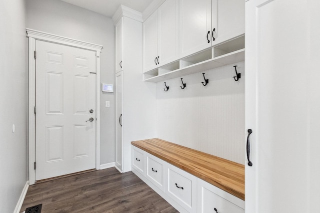 mudroom featuring visible vents, dark wood-type flooring, and baseboards