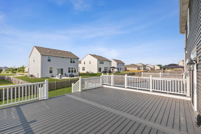 wooden terrace with a yard and a residential view