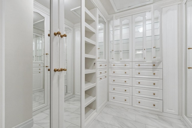 walk in closet with marble finish floor