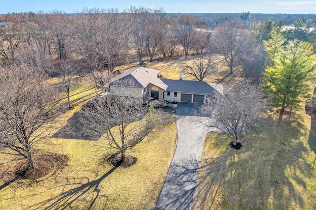 birds eye view of property featuring a view of trees