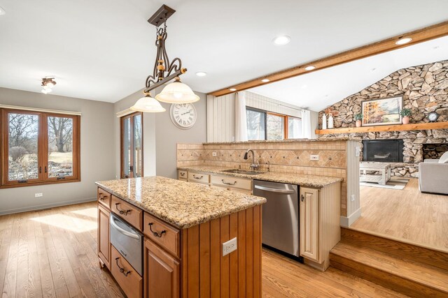 kitchen with a sink, dishwasher, a warming drawer, open floor plan, and a center island