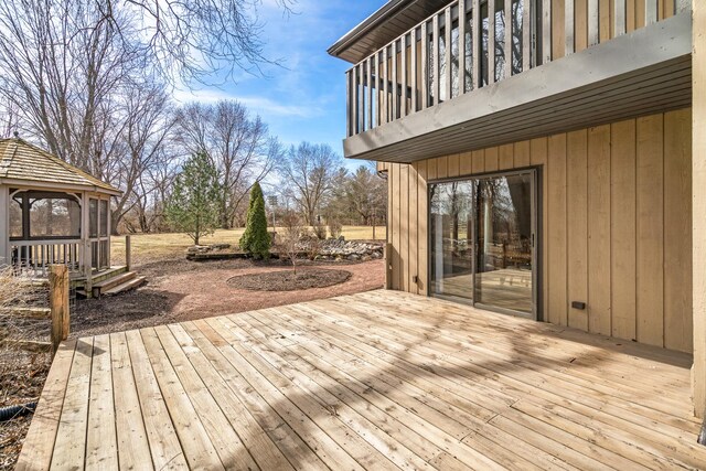 wooden terrace featuring a gazebo