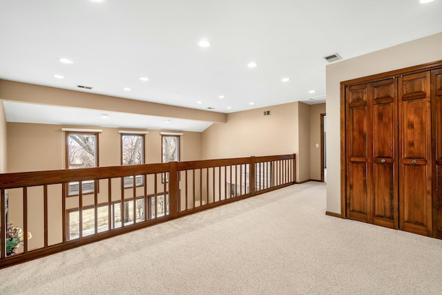 interior space with light carpet, visible vents, and recessed lighting