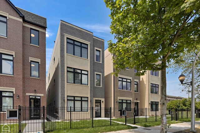 view of building exterior with a fenced front yard