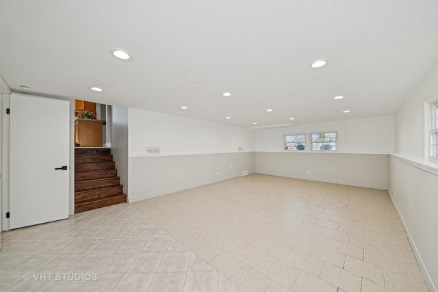 empty room with stairway, light tile patterned floors, recessed lighting, and baseboards