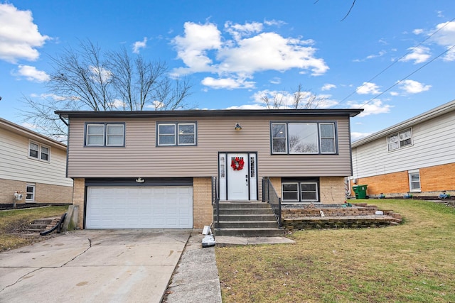 bi-level home with concrete driveway, a garage, brick siding, and a front lawn