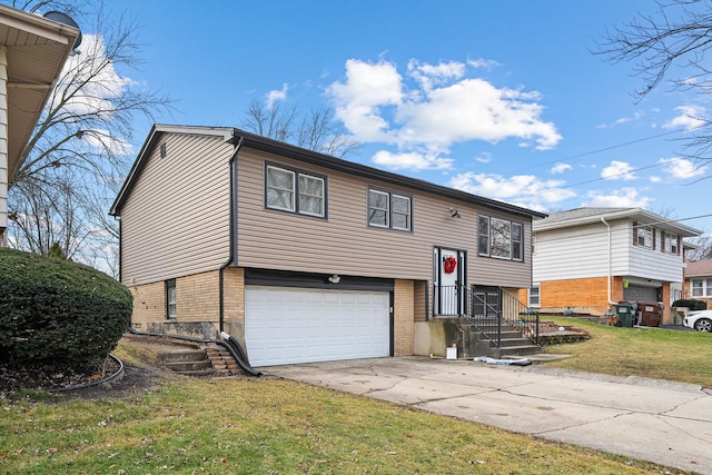 raised ranch featuring brick siding, a garage, driveway, and a front lawn