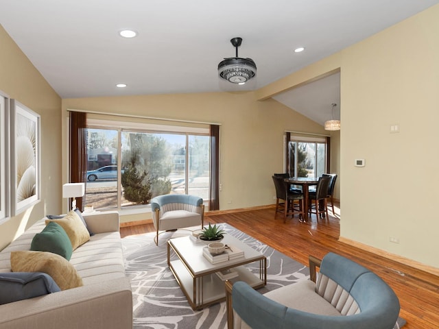 living room featuring vaulted ceiling, plenty of natural light, wood finished floors, and recessed lighting