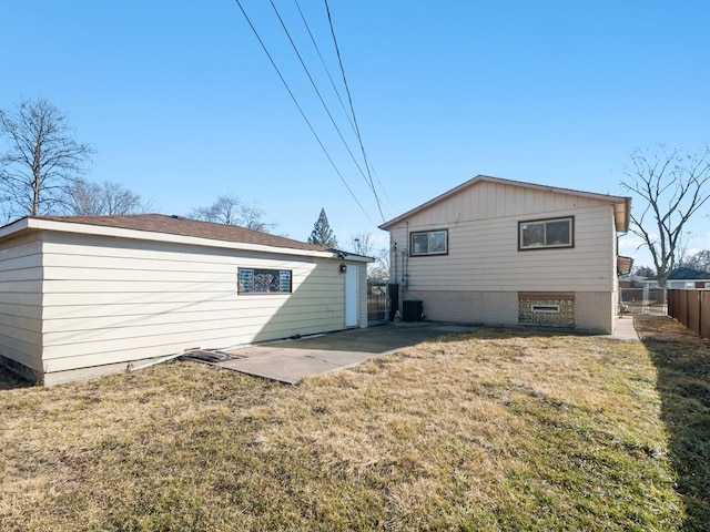 back of house featuring a patio, fence, and a lawn