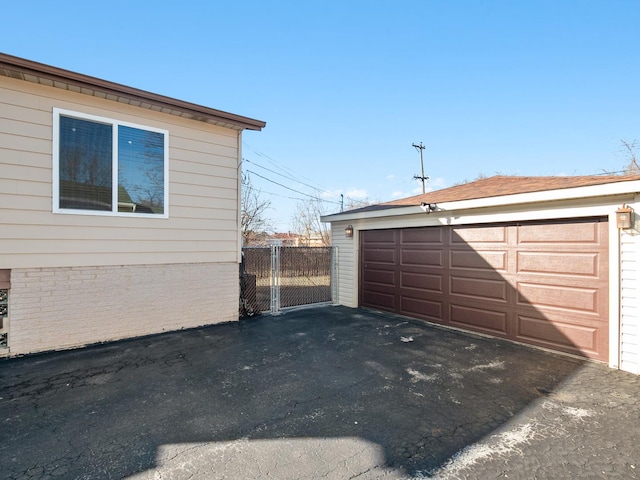 detached garage featuring fence