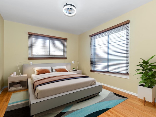 bedroom featuring baseboards and wood finished floors