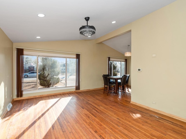 interior space featuring recessed lighting, baseboards, hardwood / wood-style flooring, and vaulted ceiling