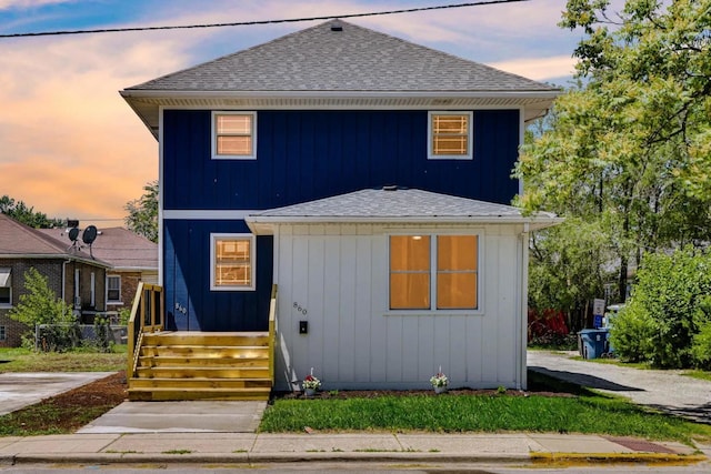 view of front of home with a shingled roof