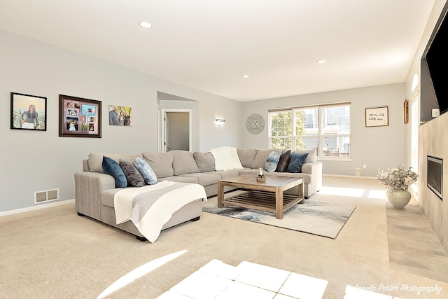 living area with light carpet, recessed lighting, visible vents, and baseboards